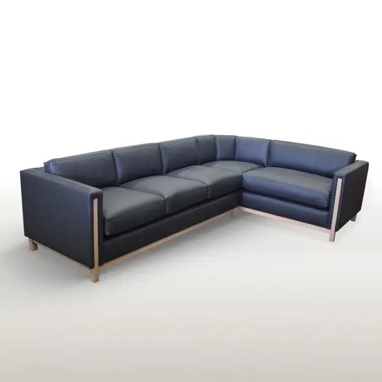 The Bain Sectional is a sophisticated piece that perfectly balances contemporary style with timeless comfort. The exposed wood detailing on the arms, legs and apron subtly contrasts the precise upholstery of the frame and cushions. These many features work together seamlessly to create a rich medley of tactile and aesthetic beauty in a sectional unlike any other.